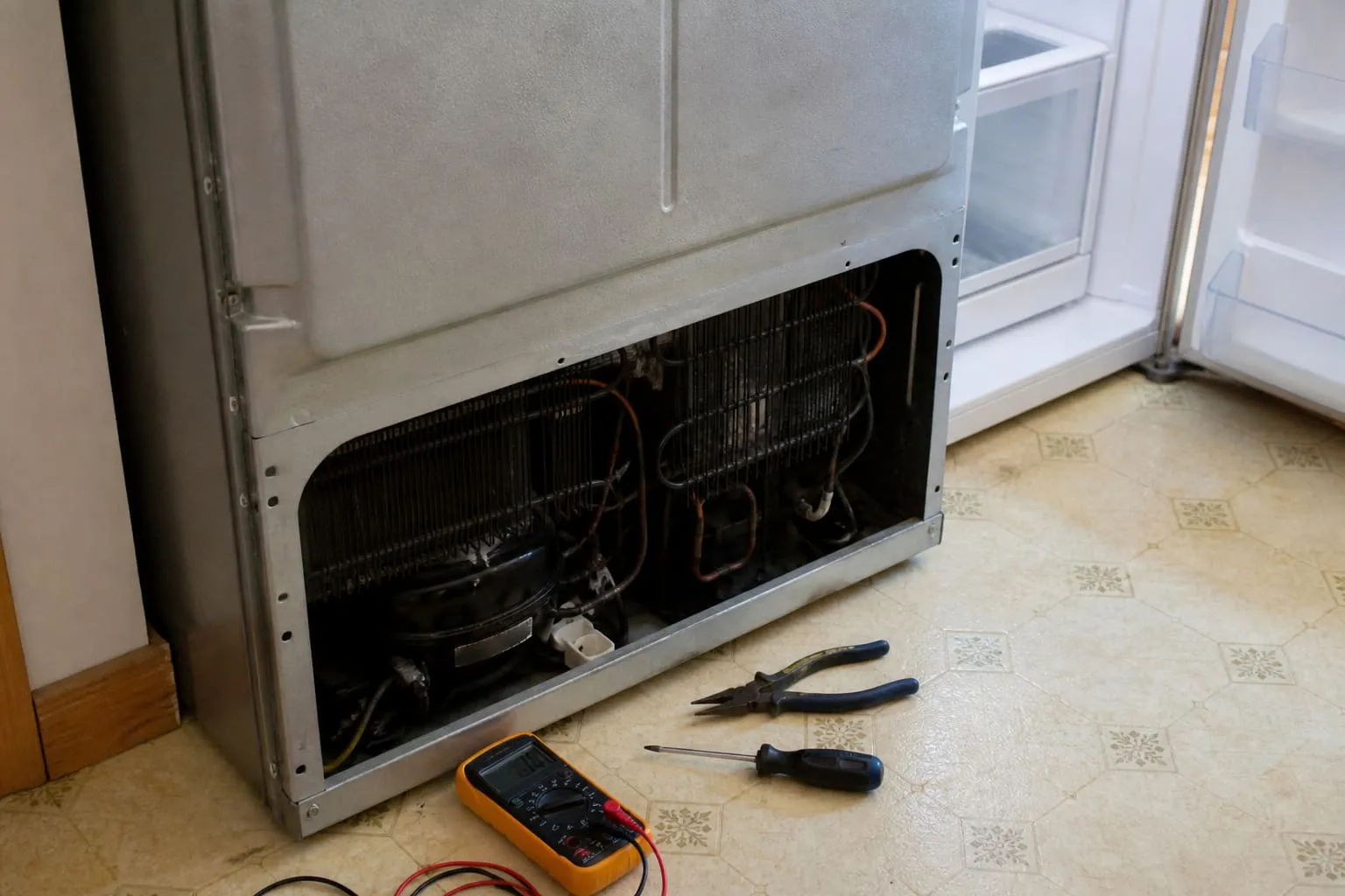 Fridge freezer open during a repair visit