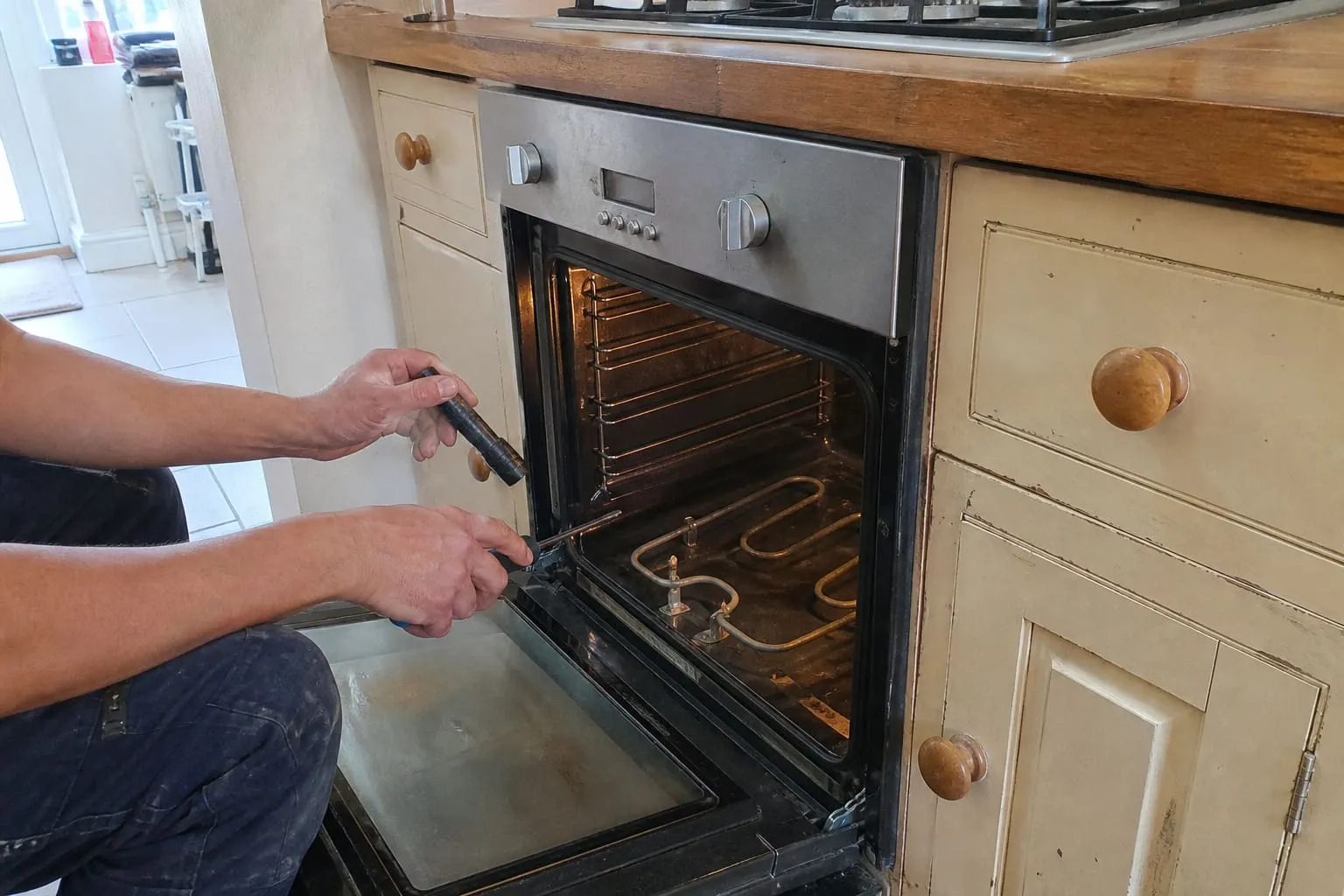 Engineer working on an open domestic oven